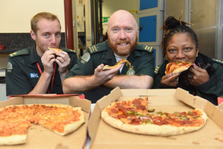 Staff at our Waterloo control room tuck into pizza kindly bought by a documentary fan