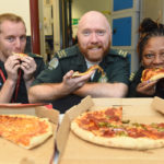 Staff at our Waterloo control room tuck into pizza kindly bought by a documentary fan