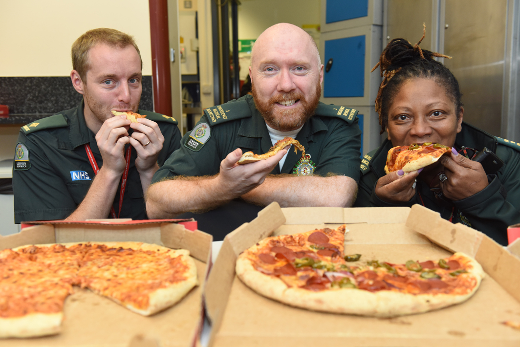 Staff at our Waterloo control room tuck into pizza kindly bought by a documentary fan
