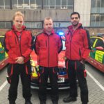 Crew from the Physician Response Unit in front of car