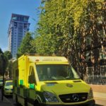 An ambulance in the sunlight with blue skies in background