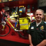 Tom next to his bicycle in the exhibition