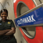 Chaniece Dennis next to Southwark station sign