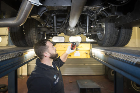 Mechanic servicing an NHS vehicle