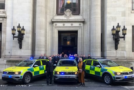 Three new response cars parked in front of the Freemasons building with people stood behind