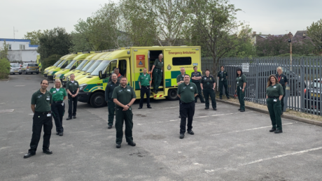 A group of people stood - at a safe distance from one another - in front of a row of ambulances. Some are in the CFR uniform and others are in LAS uniform