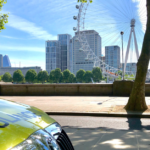 ambulance car parked with London Eye and blue skies in background