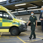 Prime Minister walks past ambulance alongside female medic