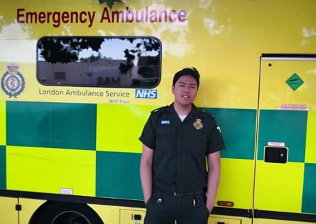 Sheqal Lim stood in front of an ambulance in green uniform