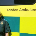 Hina in Service uniform next to ambulance