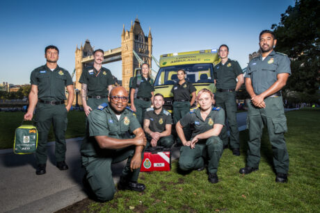 a group of paramedics in front of ambulance and Tower Bridge