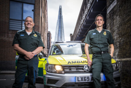 Gary and Fabio stood in front of an ambulance car with The Shard in background