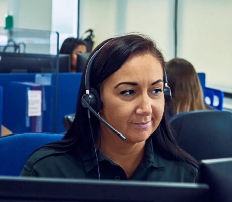 Mia with a headset on in the 111 control room