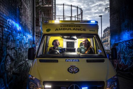 Stuart and Rachel smiling to each other in ambulance cab