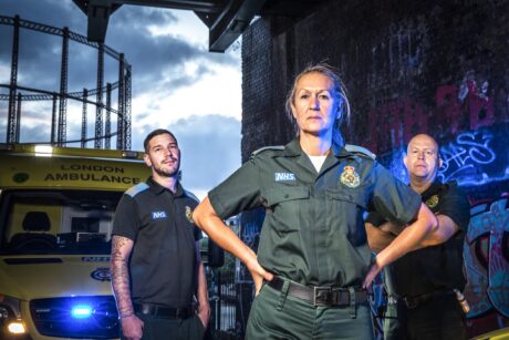 Stuart, Rachel and Pete stood in front on an ambulance in a dark setting