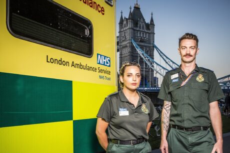 Orani and Adam next to an ambulance with Tower Bridge in background