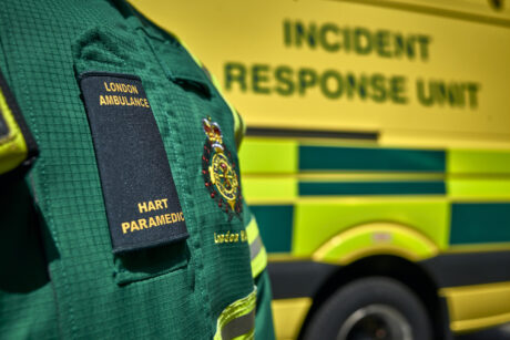 A HART paramedic in uniform in front of a HART vehicle