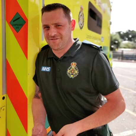 Paddy stood next to an ambulance in his Service uniform