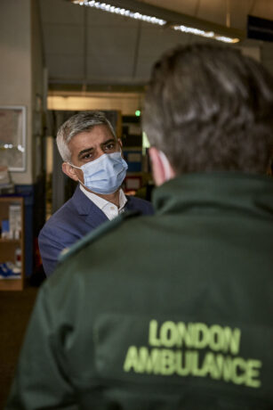 Mayor of London speaking to a LAS staff member who is shown from behind with London Ambulance uniform