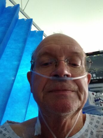 Brian in hospital with a nasal cannula