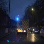 an ambulance with flashing lights on a dark street