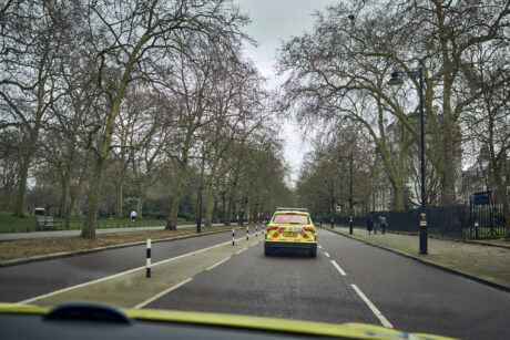 Rear of an ambulance car as it drives on a London street