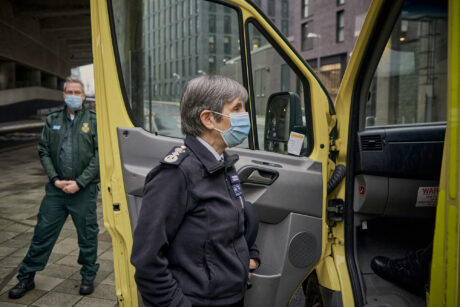 Met Commissioner stands next to an open ambulance door speaking to people in the cab