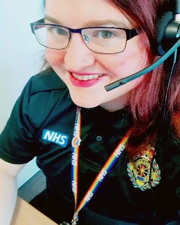 Brooke in her LAS uniform with a LGBT rainbow lanyard and a call headset on