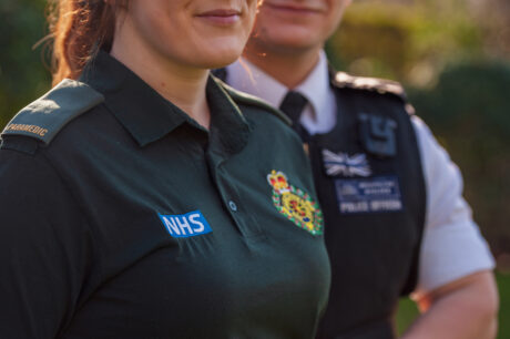 Rob and Paige in uniform posing for a photo 