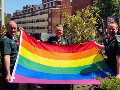 LAS LGBT Co-Chairs Lee, Jules and Alex holding up the rainbow flag