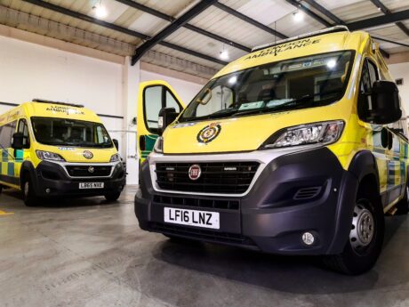 Two Non Emergency Transport Service ambulances parked in an ambulance station