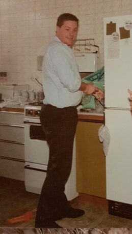 An old photo of Paul in a kitchen