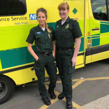 Recent image of millie and Tina in LAS uniform in front of ambulance