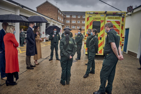 Duke and Duchess stood in conversation with uniformed members of London Ambulance Service