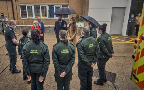 Duke and Duchess stood in conversation with uniformed members of London Ambulance Service