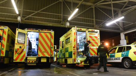 A row of ambulances being prepared in an ambulance station