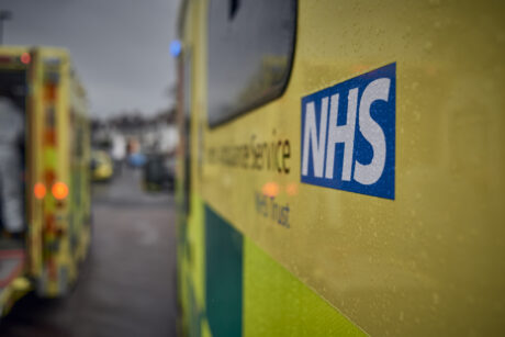 The side of an ambulance showing the NHS logo