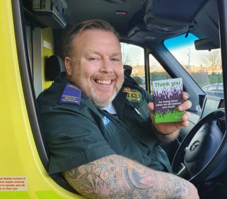 Robbie photographed in an ambulance cab smiling