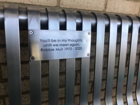 The engraving on the bench which reads You’ll be in my thoughts, until we meet again. Robbie Muir 1972 to 2020