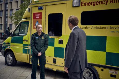 Secretary of State Matt Hancock in conversation with a paramedic next to an ambulance