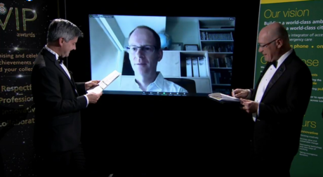 Ian on a video screen receiving the Innovative award