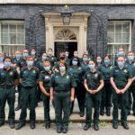 A group of medics in LAS uniform stood outside the door to 10 Downing Street