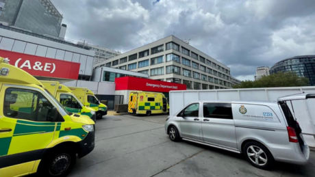 A tea Truck parked at a hospital bay alongside ambulances