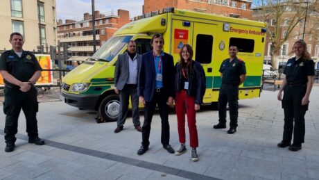 Nicolas and Alaia (front) with medics (from left) John, Vijay, Junaid and Kirsty stood in front of an ambulance