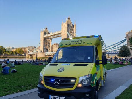 Ambulance in front of Tower Bridge of sunny day