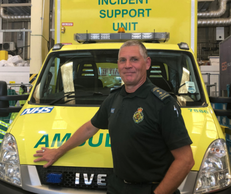 Stuart's colleague Andy stood in front of an ambulance vehicle