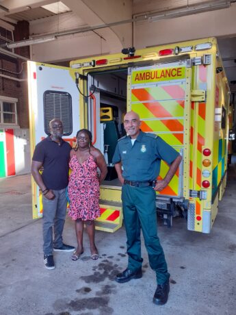 Paramedic Raj Mann with Omar's parents, Diane and Jeff in front of an ambulance