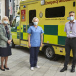 Heather Lawrence, Ruth May and Daniel Elkeles in front of an ambulance