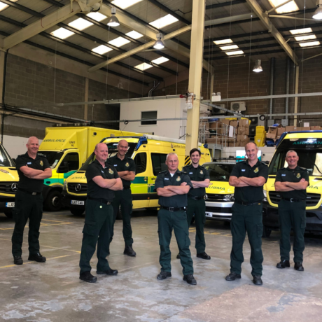 Stuart and his colleagues stood in a group in an ambulance base for a group photograph