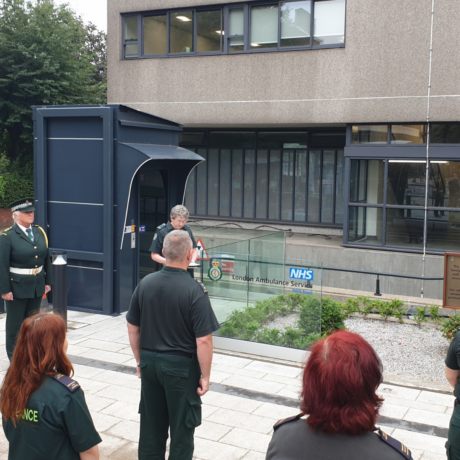 A small group of LAS staff observing a silence in our headquarters memorial garden